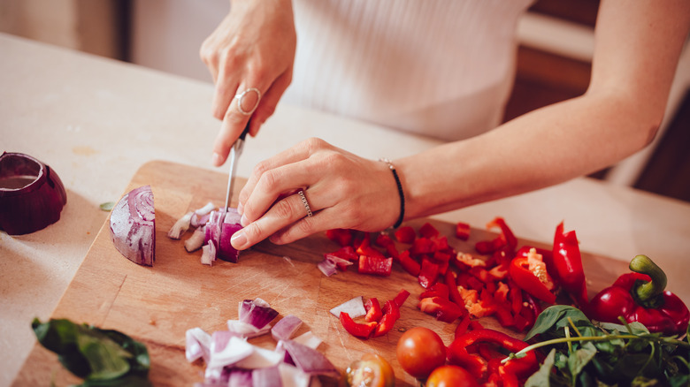 slicing onions on cutting board