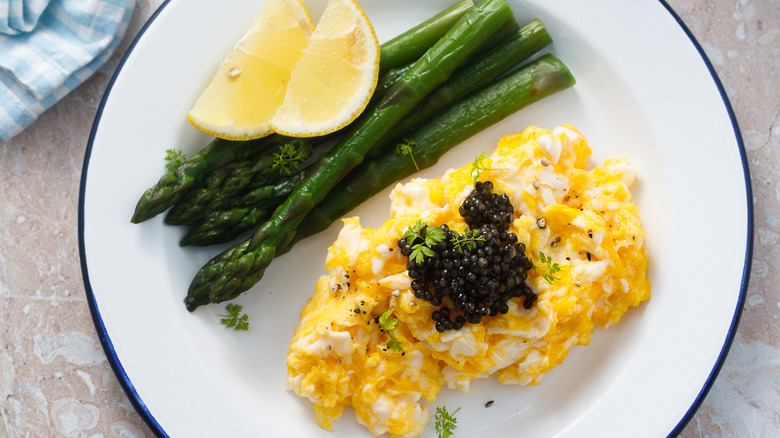 Caviar on eggs with asparagus