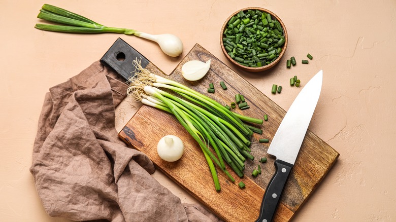 Slicing scallions on cutting board