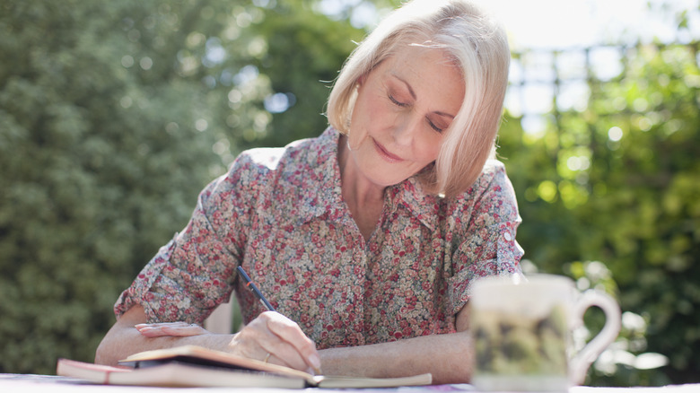 woman writing in journal