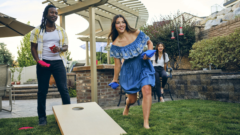 two people playing cornhole