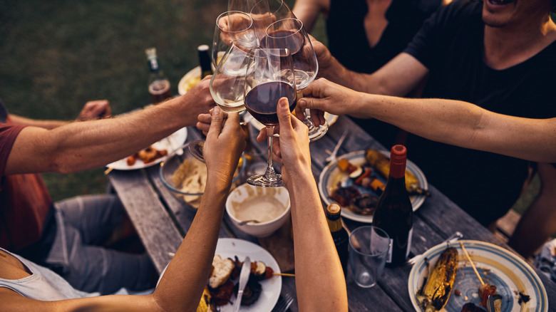 people toasting with wine glasses