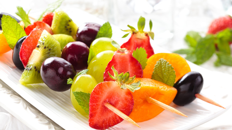 Fruit kabobs on white plate