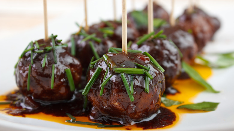 Toothpicks in grape jelly meatballs