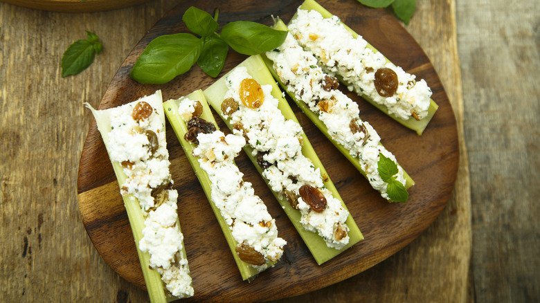 Stuffed celery on wooden board