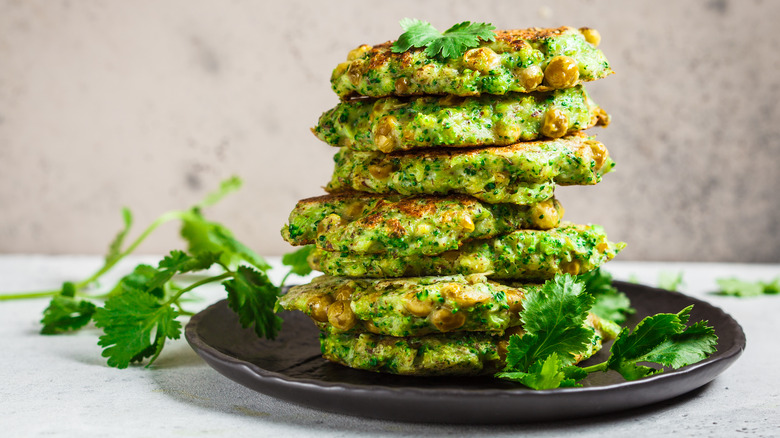 Zucchini fritters stacked on plate