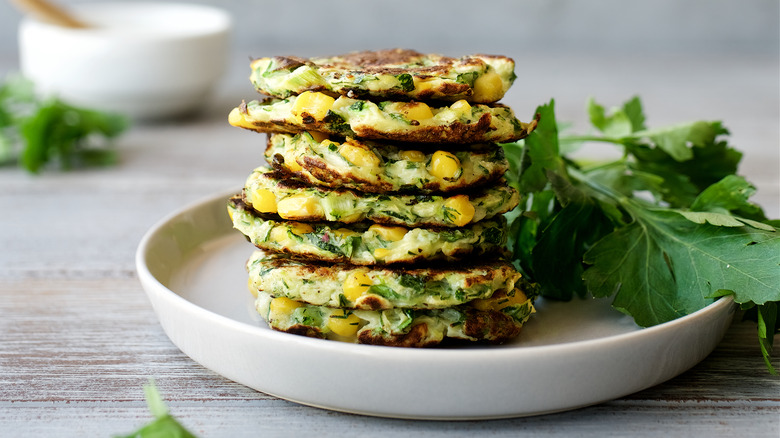 Zucchini pancakes stacked on a plate