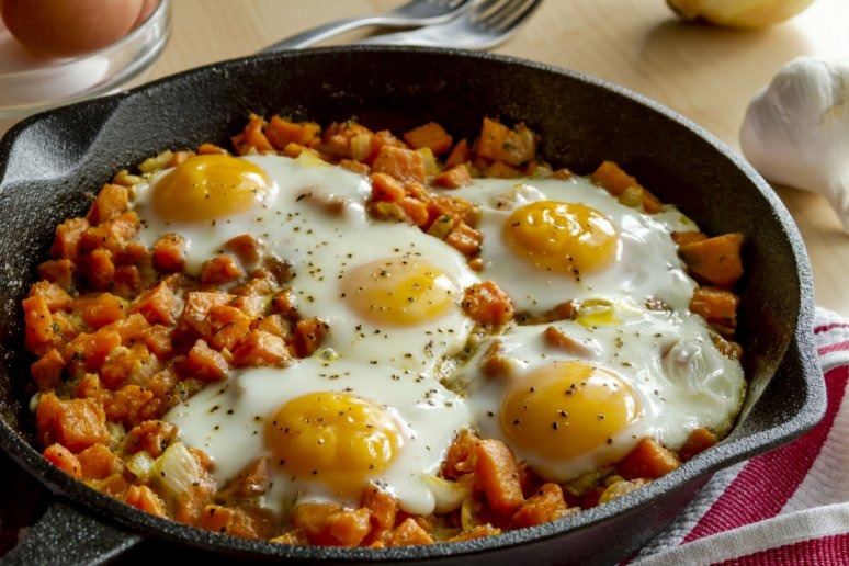 Sweet Potato Hash With Caramelized Onions, Sausage, and Eggs