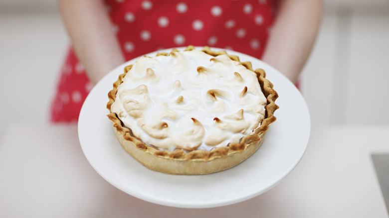 person holding meringue pie