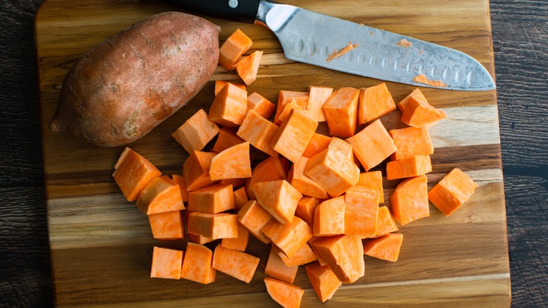 Chopped sweet potatoes on board