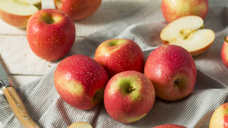 whole and cut pink lady apples