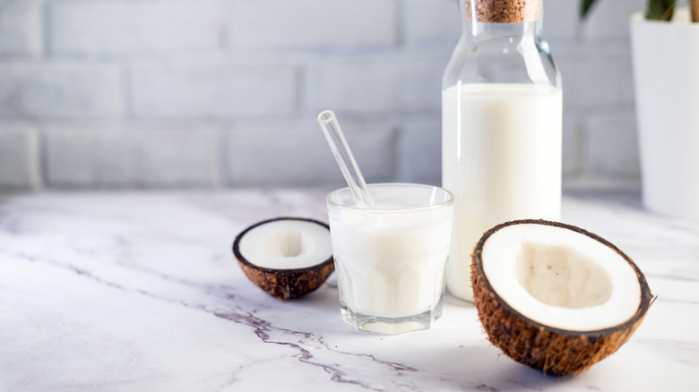 Coconut milk and halved coconut