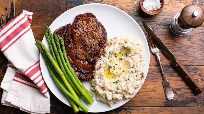 dinner plate with steak and mashed potatoes