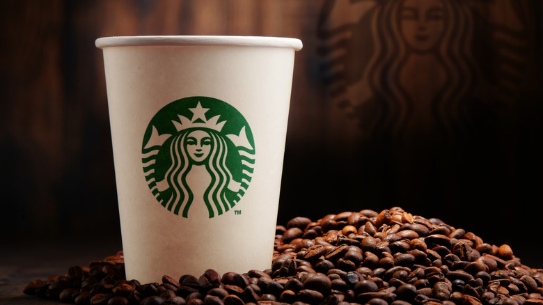 starbucks cup with coffee beans