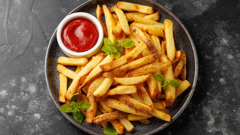 Homemade fries on plate with ketchup