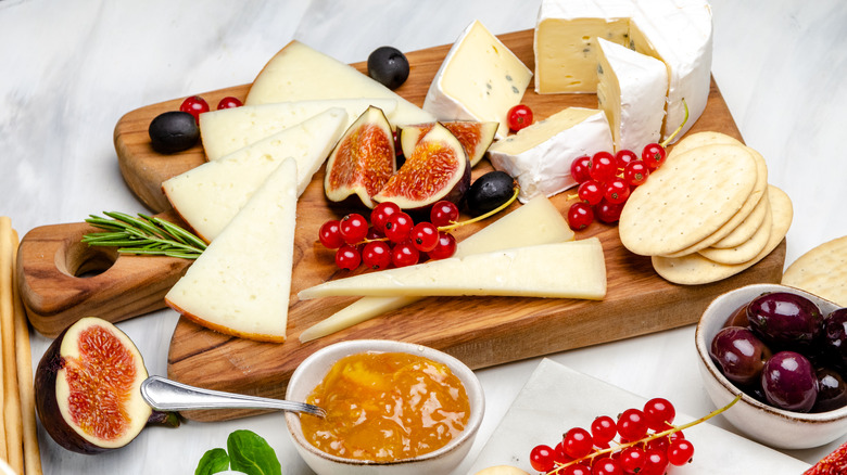 Fruit and cheese board with fruit spread and crackers