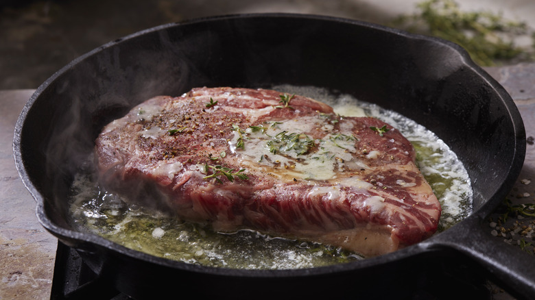 steak searing in cast iron skillet