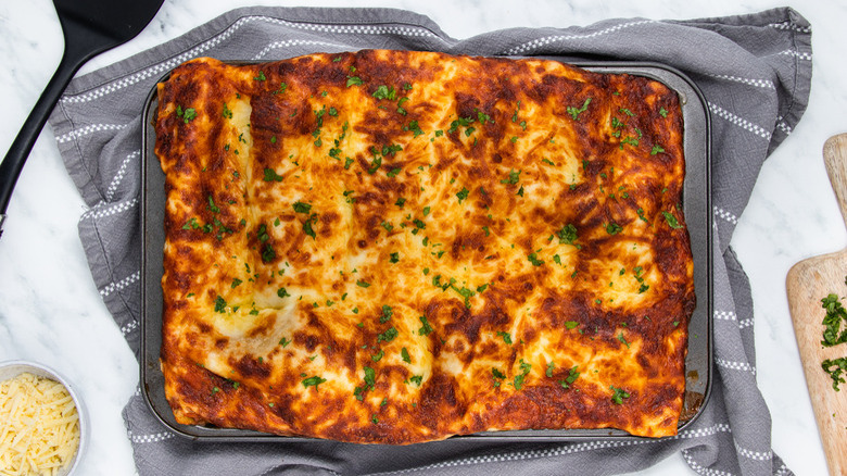 lasagna in pan on towel