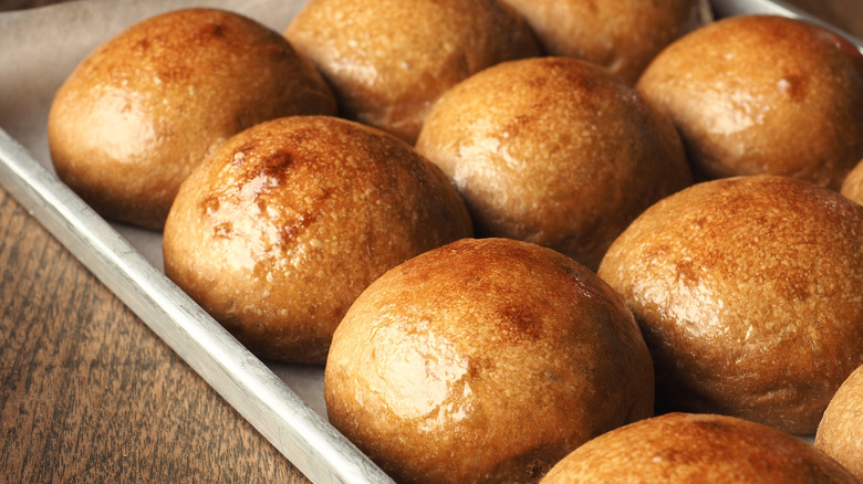 Shiny dinner rolls on tray