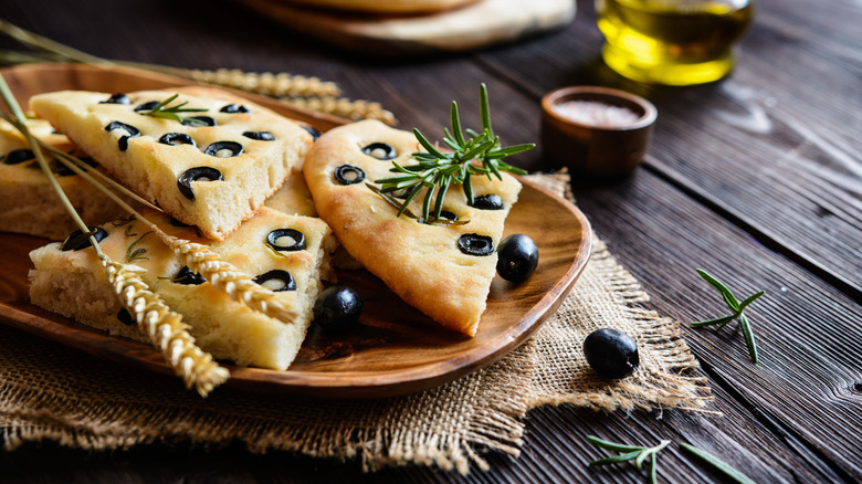 Olive focaccia on wooden plate