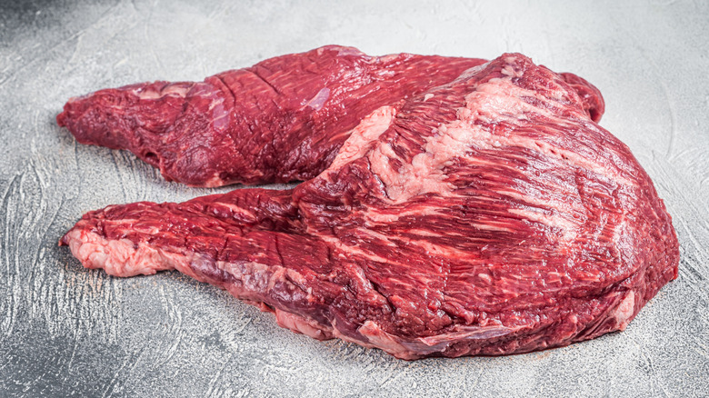 Raw tri-tip steak on grey countertop