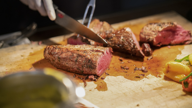 carving meat on wooden board