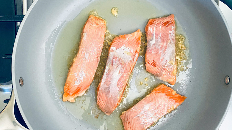 salmon fillets in frying pan