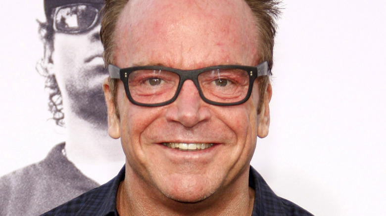 Tom Arnold wearing glasses