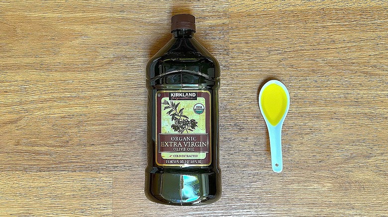 Bottle and spoonful of Kirkland Signature Organic Extra Virgin Olive Oil