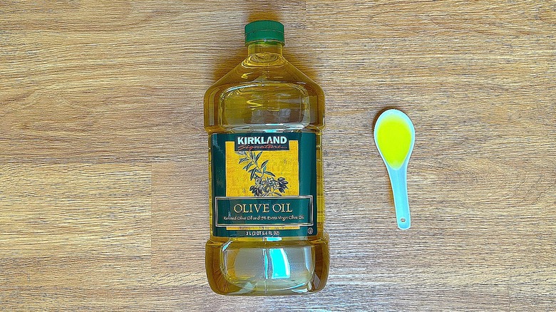 Bottle and spoonful of Kirkland Signature Olive Oil