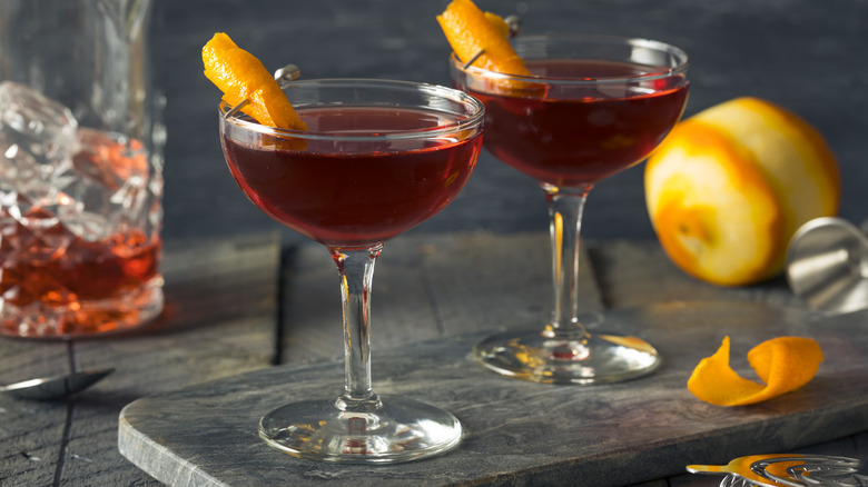 two boulevardier cocktails with orange peel