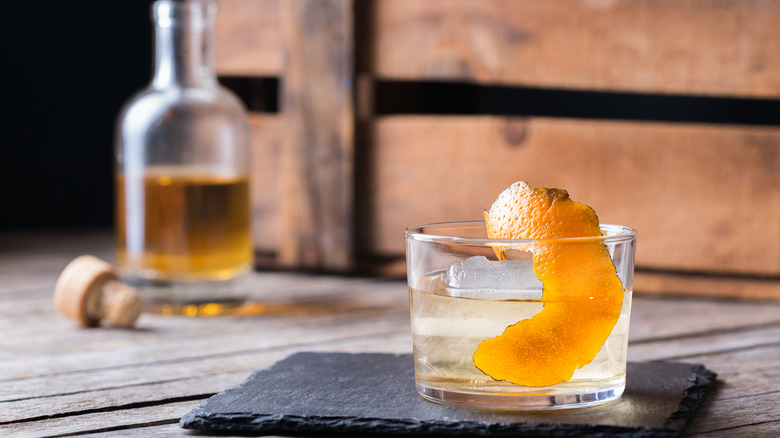 Old Fashioned cocktail with bottle in background