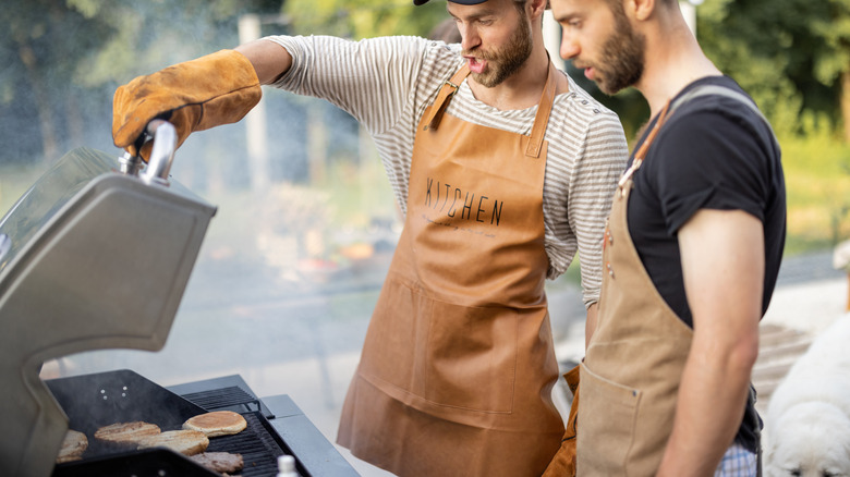 men cooking with gas grill