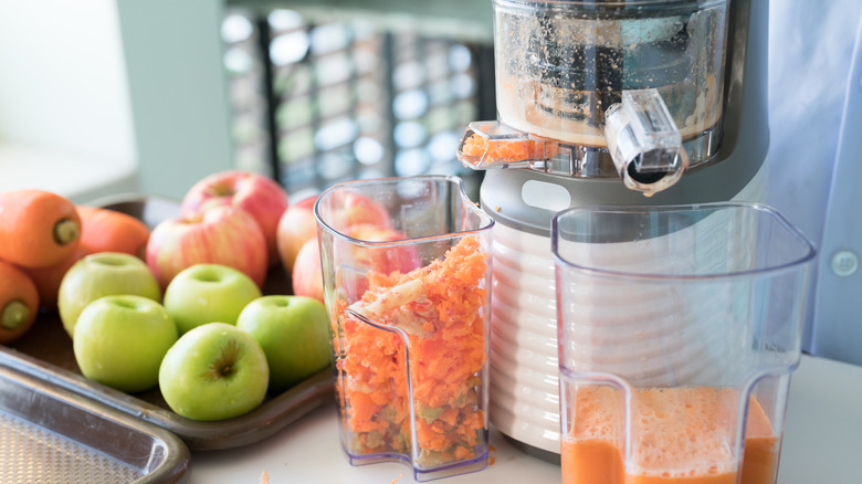 juicer with apples and carrots