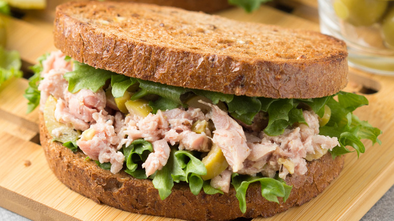 tuna salad sandwich on wooden platter