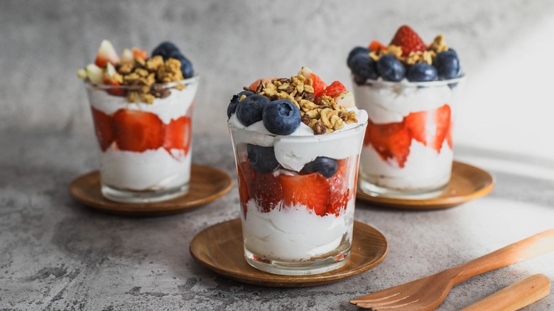 three fruit parfaits in cups