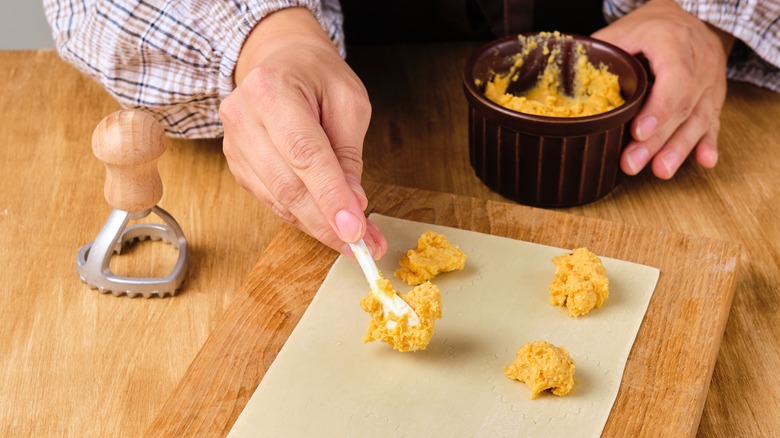 woman filling ravioli