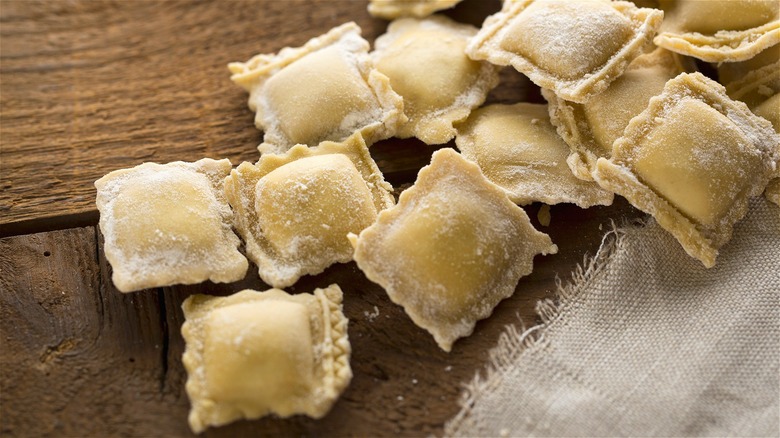 fresh ravioli on wooden board