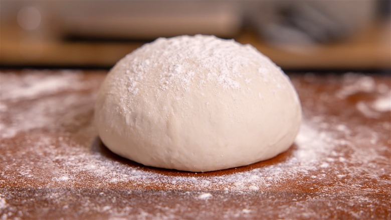 person holding dough ball