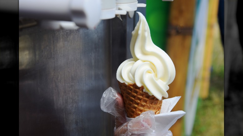 person using soft serve machine