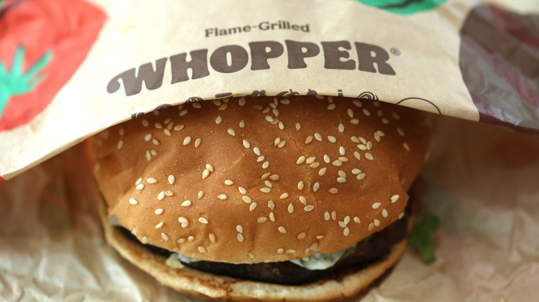 Whopper sandwich in paper packaging