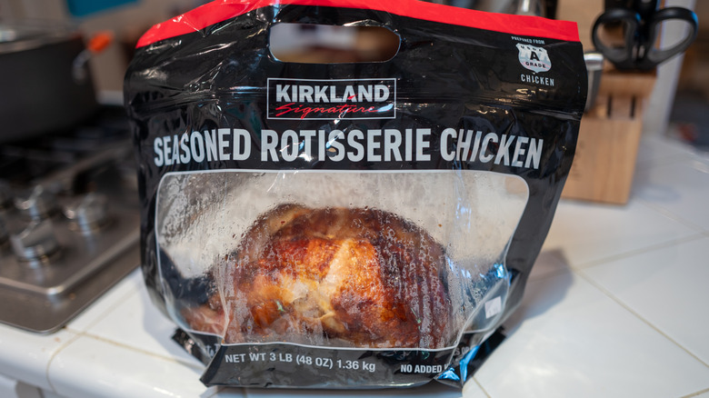 Costco rotisserie chicken in plastic bag, sitting on kitchen counter