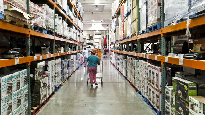 View of Costco interior, with customers walking through aisle