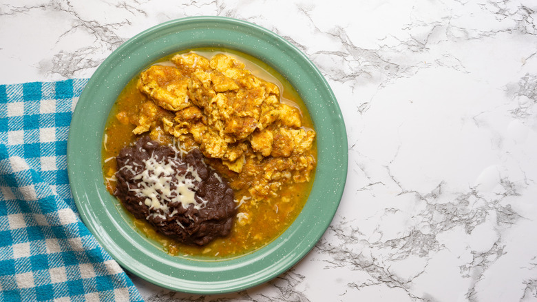 refried beans and eggs in sauce