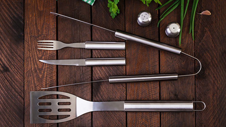 Metal utensils on wood background