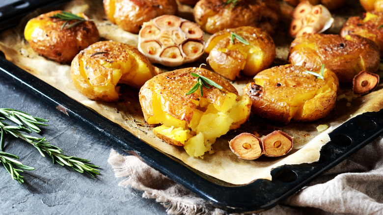 potatoes and garlic on a baking sheet