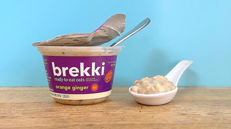 Container and spoonful of Brekki Orange Ginger-flavored ready-to-eat oats