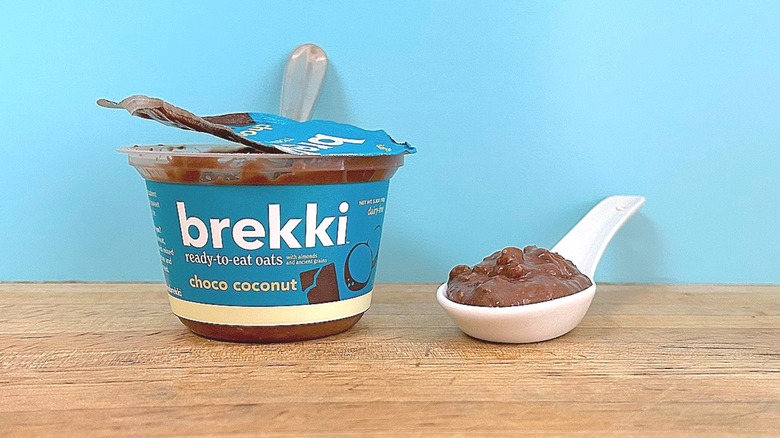 Container and spoonful of Brekki Choco Coconut-flavored ready-to-eat oats