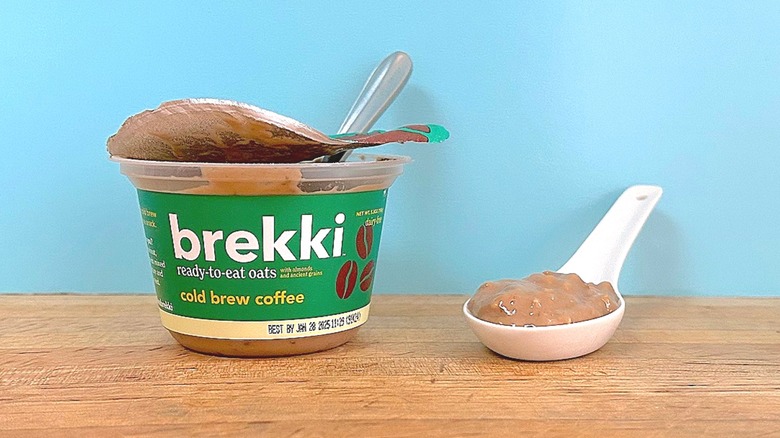 Container and spoonful of Brekki Cold Brew Coffee-flavored ready-to-eat oats