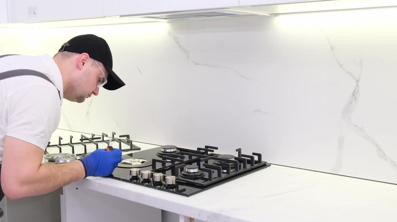 Engineer working on gas stove top